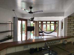 a kitchen with a sink and a ceiling fan at Apartamentos Morada do Canto - 130m da praia principal Bombinhas in Bombinhas +20 photos