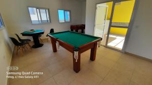 a pool table in a room with a table at Vila Monrealle in Ubatuba