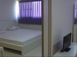 a small bed in a room with a window at Impact -Challenger Muang thong Thani in Thung Si Kan +2 photos