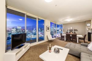 a living room with a view of a city at Exclusive Stays - The Centurion in Melbourne