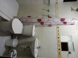 a bathroom with a toilet with flowers on the wall at HOTEL CASA GARCES in Cartagena de Indias