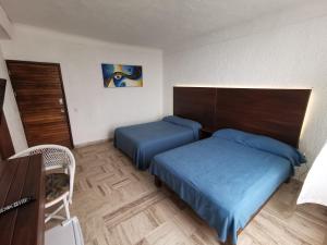 Giường trong phòng chung tại 62 ROOM PENINSULA CAPITAN