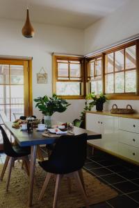 a kitchen with a dining room table and chairs at Lothlorien in Mount Beauty