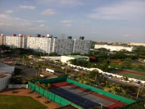 a view of a city with a tennis court and buildings at Asia Don Mueang Bangkok Condominium in Thung Si Kan
