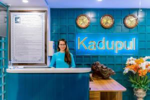 a woman standing at a counter in a kuala lumpur office at KADUPUL HOTEL in Quy Nhon