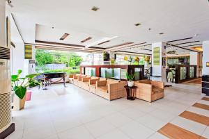 a large living room with couches and a table at Alpa City Suites Hotel in Cebu City
