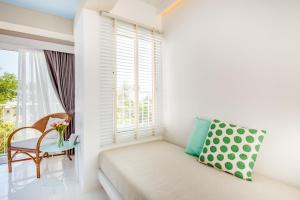 a living room with a couch and a window at Baan KangMung Hua Hin On The Beach in Hua Hin