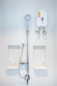 a shower in a bathroom with two sinks at Baan KangMung Hua Hin On The Beach in Hua Hin