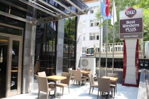 a restaurant with tables and chairs in front of a building at Best Western Plus Center Hotel in Ankara