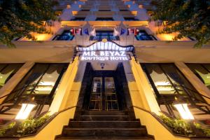 a stairway leading up to a building with a sign on it at Mr BEYAZ HOTEL in Istanbul