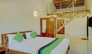 a bedroom with a white bed with a staircase at Hotel Lake Paradise Mahabaleshwar in Mahabaleshwar