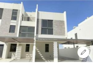 a large white building with a staircase in front of it at Dream house dubai in Dubai