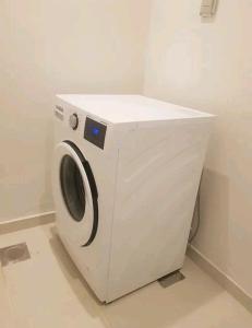a white washing machine sitting in a room at Dream house dubai in Dubai
