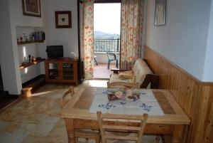 un soggiorno con tavolo e divano di Acero Appartamenti a Manciano