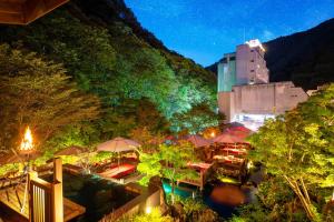 a restaurant with tables and umbrellas in a city at Harataki in Aizuwakamatsu