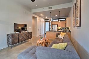 a living room with a couch and a kitchen at Urban Escape in SoLA with Private Patio! in Austin