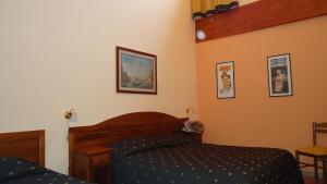 Letto o letti in una camera di Hotel Archimede Ortigia