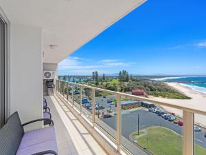 a balcony with a view of the ocean and a beach at Ebbtide 38 On The Beach in Forster
