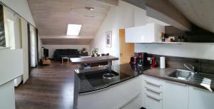 a kitchen with a sink and a counter top at Ferienwohnung Sam in Laimgrub