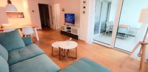 a living room with a couch and a table at BodenSEE City Apartment Friedrichshafen CASA GRAF in Friedrichshafen