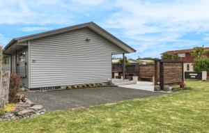 a house with a garage and a fence at Marshall's Haven in Hahei