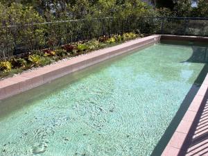 a pool of clear blue water in a backyard at Twin Pines 401 CBD Location in Forster