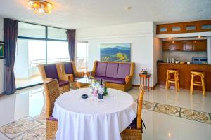 a living room with a white table and chairs at Markland Beach View in Pattaya