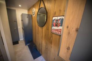 a hallway with a mirror on a wooden wall at Superbe -Appartement 2 personnes - Tignes le Lac - 813 - Le Palafour in Tignes