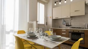 een keuken met een tafel met wijnglazen erop bij Italianway - Quarnaro 2 in Monza