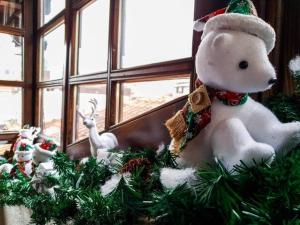a christmas decoration of a stuffed polar bear on a window at Hotel Tanne in Bansko