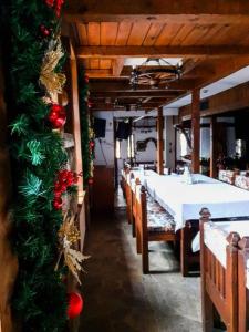 a dining room with a table and christmas decorations at Hotel Tanne in Bansko