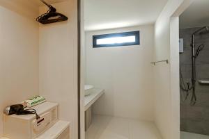 a bathroom with a shower and a sink at Nakara Long Beach Resort - SHA Extra Plus in Ko Lanta