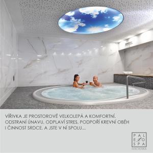 a man and a woman in a bath tub at Wellness Hotel Svachovka in Český Krumlov