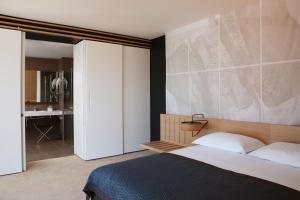 a bedroom with a bed and a bathroom at Lone Hotel by Maistra Collection in Rovinj
