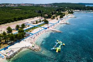 an aerial view of a beach with a boat in the water at Amazing apartment Green Paradise with pool and whirpool near the beach in Vinkuran