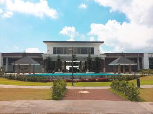 a building with a swimming pool in front of it at Wind and Sea at Wind Residences in Tagaytay