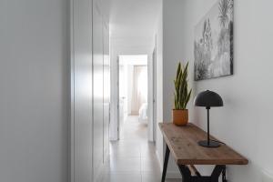 a hallway with a table and a potted plant at Royal Flats in Las Palmas de Gran Canaria