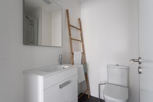 a bathroom with a sink and a ladder next to a toilet at Royal Flats in Las Palmas de Gran Canaria