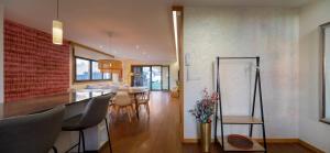 a dining room and living room with a table and chairs at Casa de ensueño en el Castro de Vigo y céntrica by Prishomes in Vigo