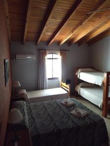 a bedroom with two beds and a window at Hotel Gala in Villa Carlos Paz