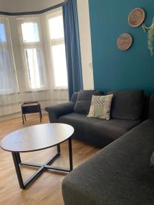 a living room with a couch and a coffee table at City Apartment Bremerhaven in Bremerhaven