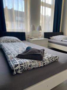 a bed with a blanket on it in a bedroom at City Apartment Bremerhaven in Bremerhaven