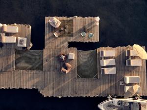 an overhead view of a wooden pier with a boat at Ekies All Senses Resort, a Member of Design Hotels in Vourvourou