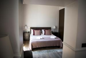 A bed or beds in a room at Holidays Suites Navona