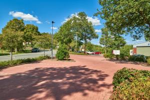 a red brick road with trees and a street light at Hotel Pfeffermühle in Siegen