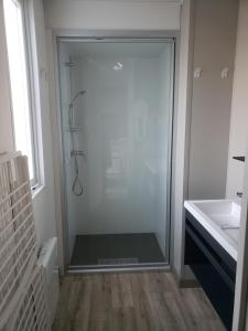 a shower with a glass door in a bathroom at Camping des Bondons in La Ferté-sous-Jouarre +20 photos