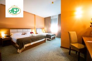 Postel nebo postele na pokoji v ubytování Agropolog Hotel & Spa + 11 fotografií