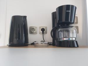 a coffee maker and a coffee pot on a shelf at Camping des Bondons in La Ferté-sous-Jouarre