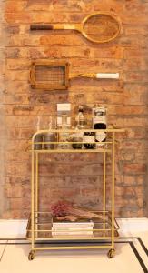 a shelf with items on it in front of a wooden wall at Thelma & You in Cape Town