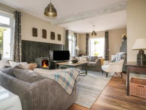 a living room with a couch and a fireplace at Crantock Lodge in Newquay